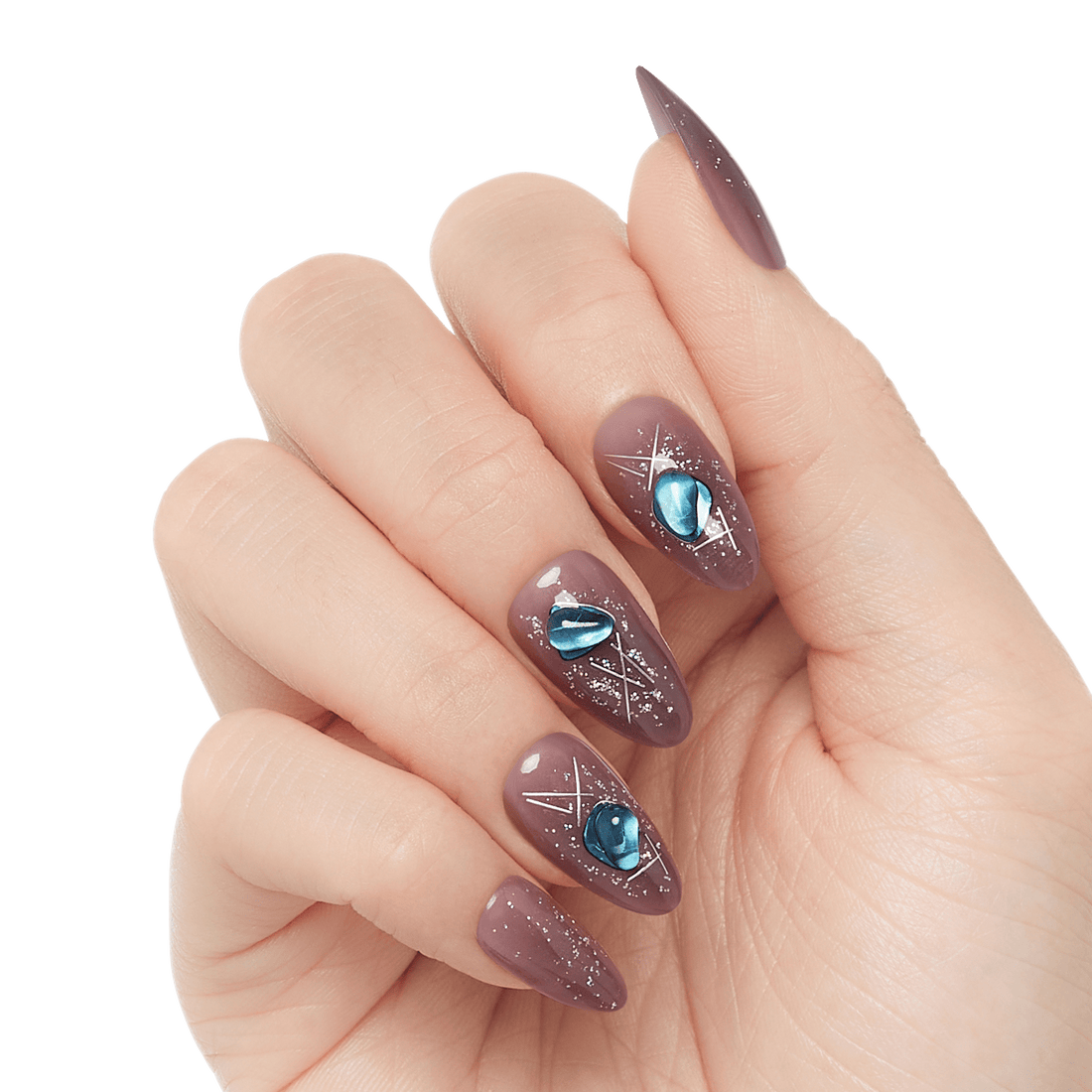 Fingernails with almond-shaped, mauve-colored press-on nails decorated with silver geometric lines and blue gem-like accents.