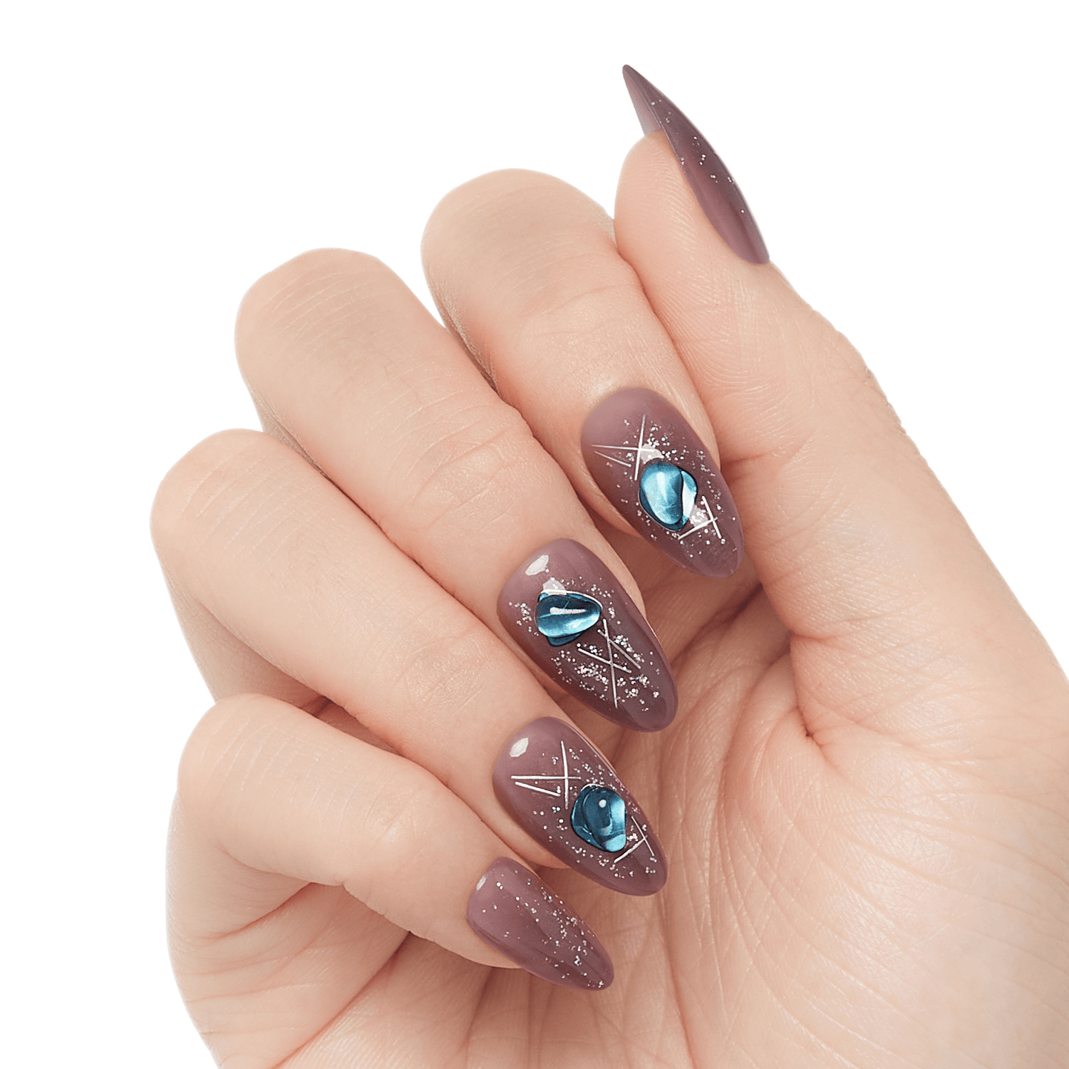 Fingernails with almond-shaped, mauve-colored press-on nails decorated with silver geometric lines and blue gem-like accents.