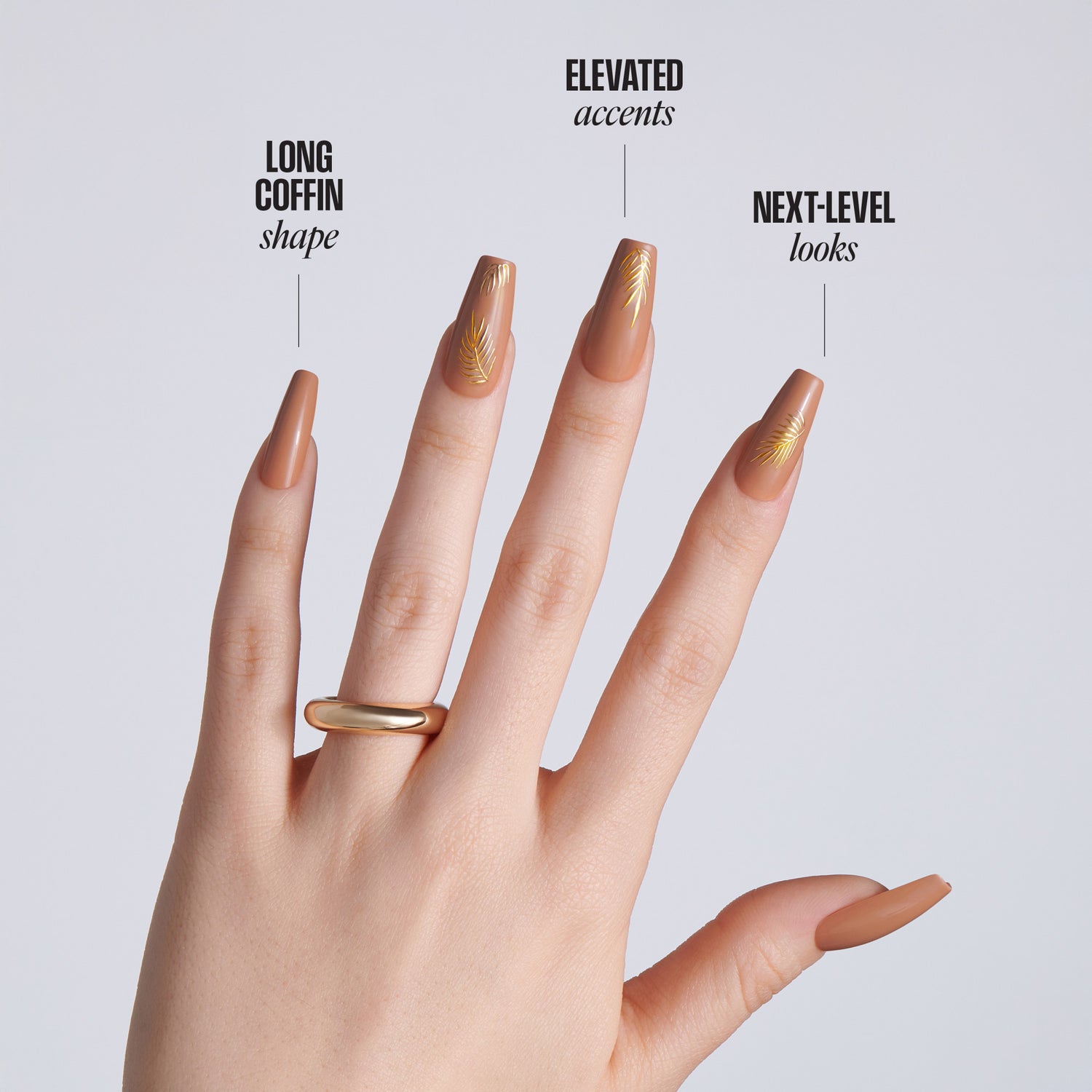 Hand with long coffin-shaped nude nails featuring gold leaf accents on a light gray background with text: Long Coffin Shape, Elevated Accents, Next-Level Looks