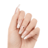 Hand with long, coffin-shaped press-on nails in light translucent pink and white tips, decorated with small gold and iridescent accents on middle fingers.