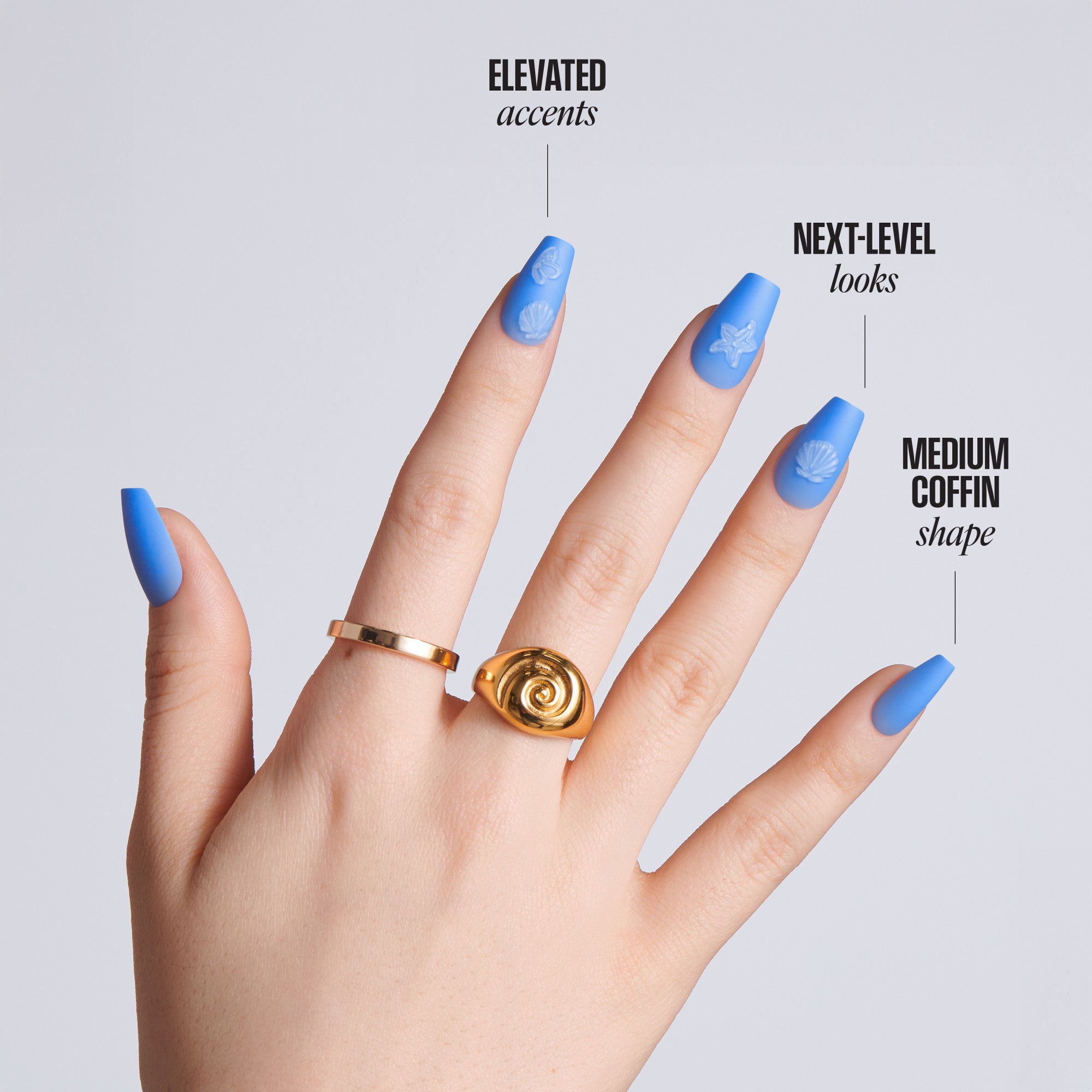 Hand with blue nail polish and gold rings on a light gray background