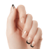 Hand showing five natural-colored nails with a metallic design: black diagonal tip on the thumb, metallic gold half-moon near the tip on the middle finger, and black tips on the index, ring, and pinky fingers.