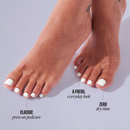 White press-on pedicure nails on feet with text "Classic press-on pedicure, A fresh everyday look, Zero dry time