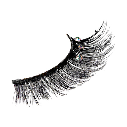 Black false eyelashes with iridescent crystal embellishments on white background.