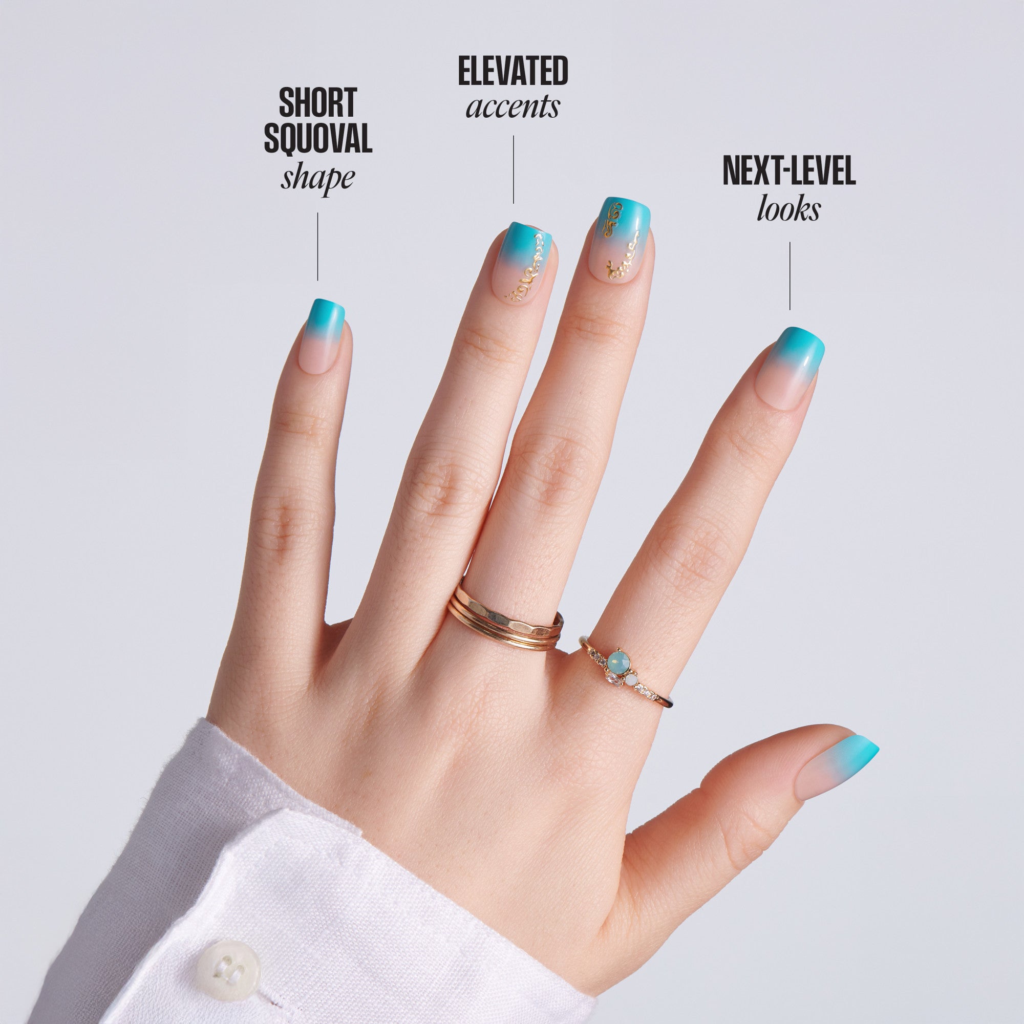 Hand with short squoval-shaped teal ombre press-on nails with gold chain accents on gray background, with text: Short Squoval Shape, Elevated Accents, Next-Level Looks